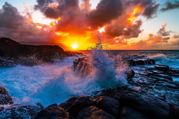 Foto gratuito hermoso paisaje de formaciones rocosas junto al mar en queens bath, kauai, hawaii al atardecer