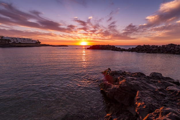 Foto gratuito un paisaje impresionante de la hermosa puesta de sol y el colorido cielo nublado reflejado en el mar