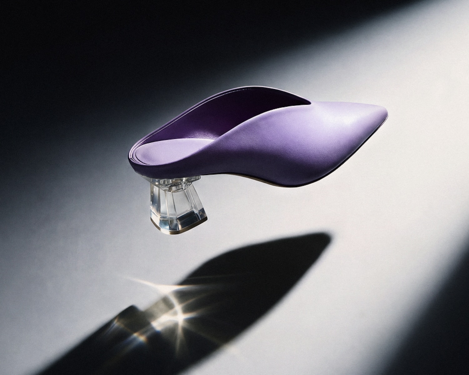 Lavender heeled mule floating in a beam of light