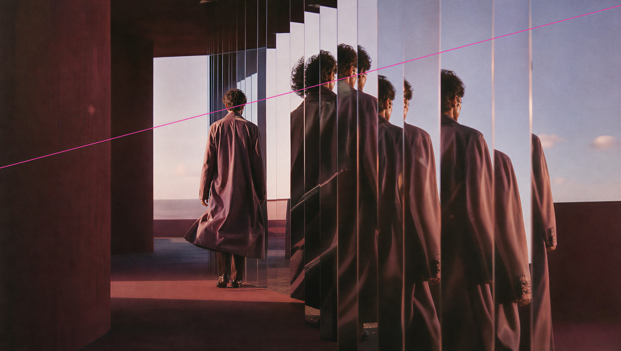 Robed figure repeated across glass panels in a sunlit room